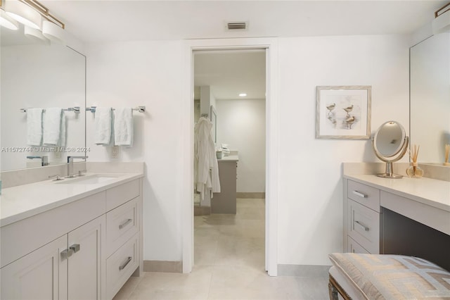 bathroom with vanity with extensive cabinet space and tile flooring