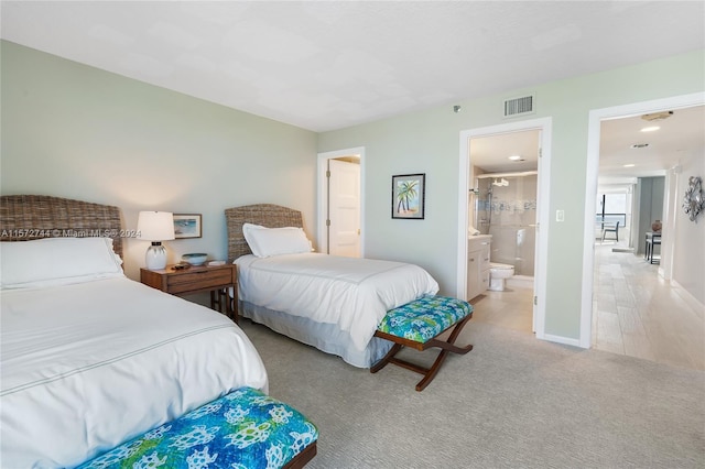 carpeted bedroom with ensuite bath