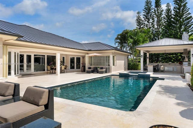 view of pool with a patio area, french doors, an outdoor kitchen, and central AC unit