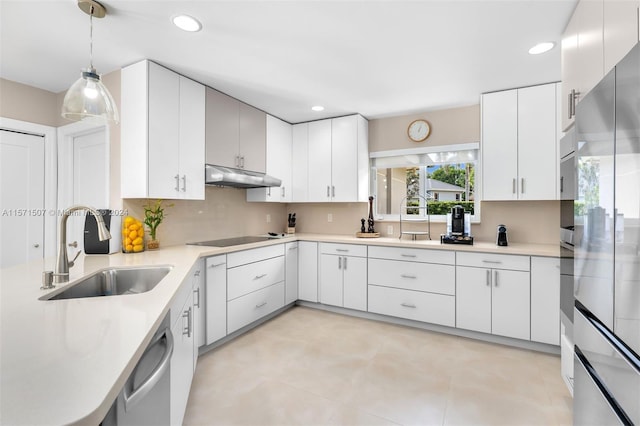 kitchen with white cabinets, sink, appliances with stainless steel finishes, and light tile floors