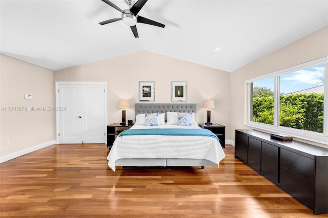 bedroom featuring light hardwood / wood-style flooring, ceiling fan, and lofted ceiling