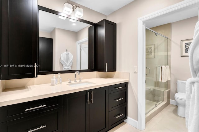 bathroom featuring walk in shower, vanity, tile floors, and toilet