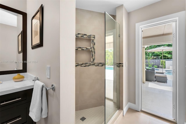 bathroom with a healthy amount of sunlight, vanity, and a shower with shower door