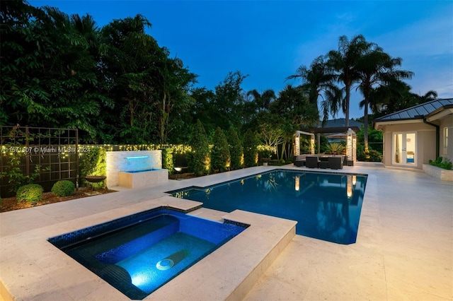 view of swimming pool featuring a patio area and an in ground hot tub