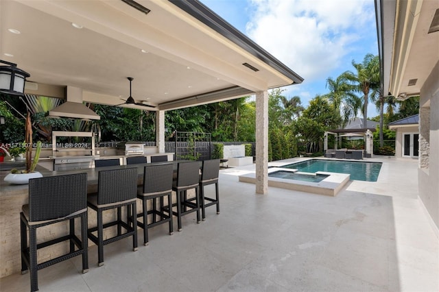 view of swimming pool with a patio area, ceiling fan, a gazebo, and exterior bar