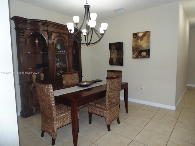 dining area featuring a notable chandelier and light tile floors