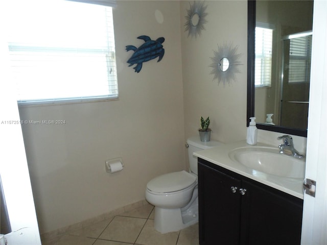 bathroom with vanity, tile floors, and toilet