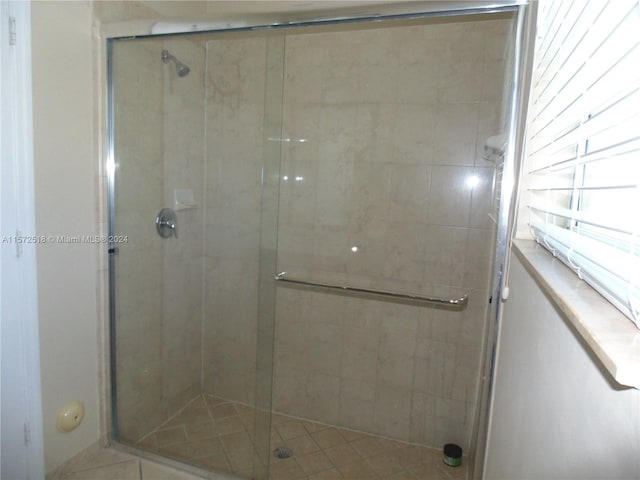 bathroom with a shower with door