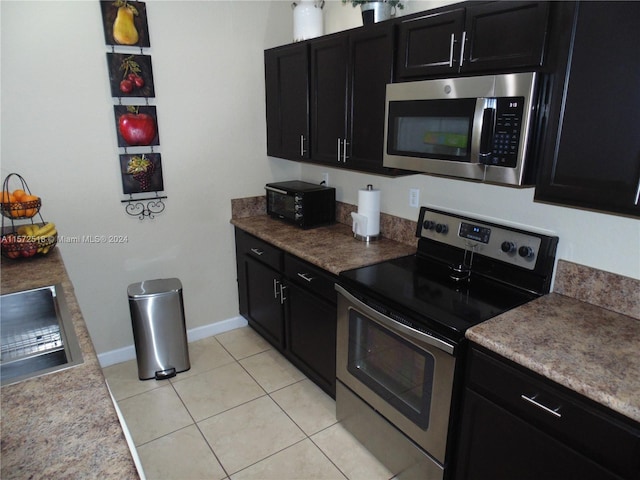 kitchen with stainless steel appliances and light tile floors