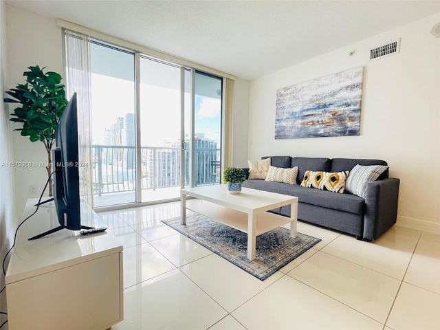 living room featuring expansive windows and light tile floors