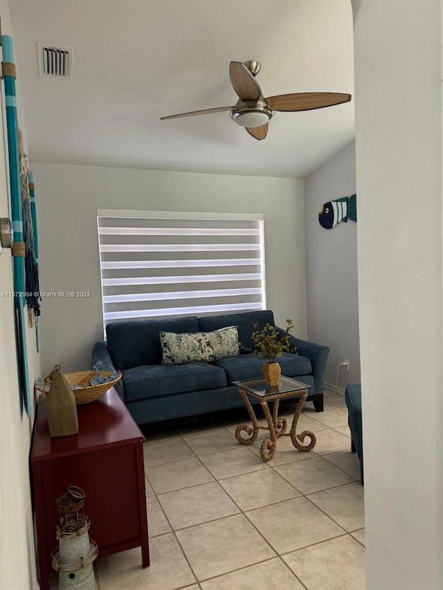 tiled living room featuring ceiling fan