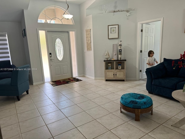 tiled entryway featuring a high ceiling