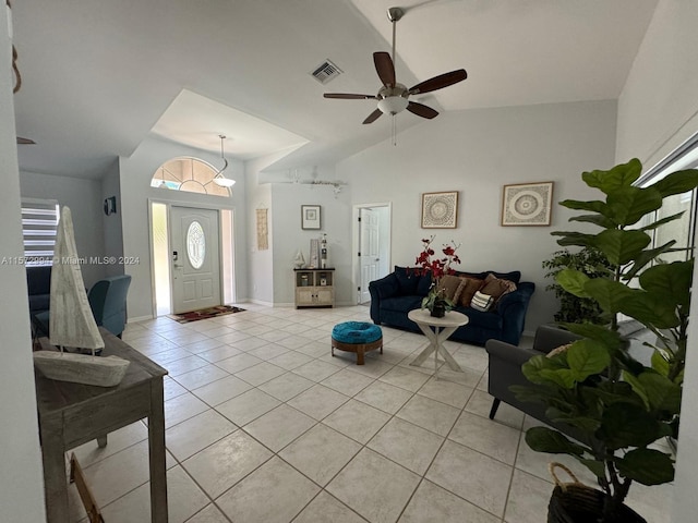 living room featuring lofted ceiling, ceiling fan, and light tile flooring