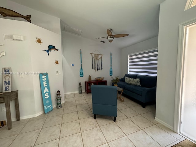 living room with a healthy amount of sunlight, ceiling fan, and light tile floors