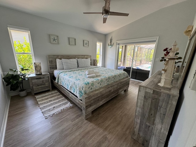 bedroom featuring access to outside, ceiling fan, dark hardwood / wood-style floors, and vaulted ceiling