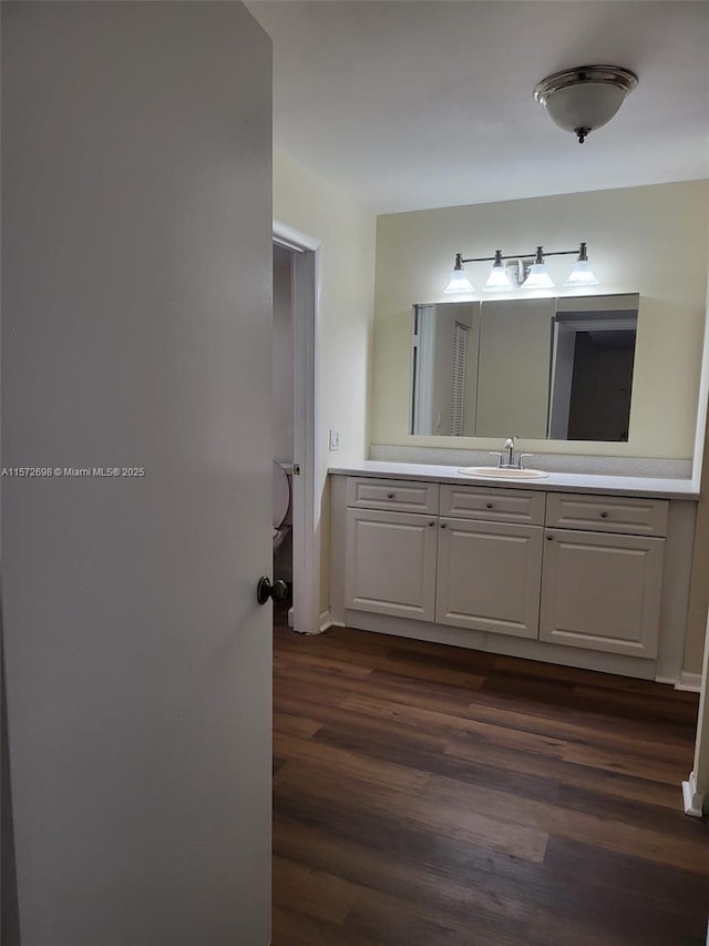 bathroom with vanity and hardwood / wood-style flooring