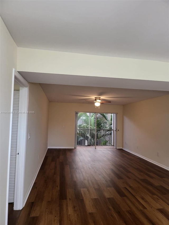 spare room featuring dark hardwood / wood-style flooring and ceiling fan