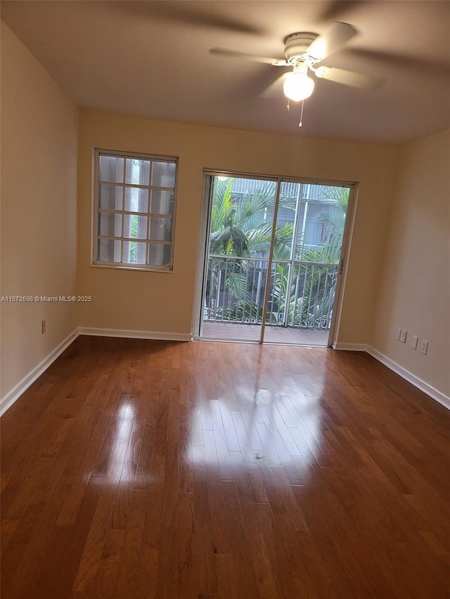 spare room featuring hardwood / wood-style floors and ceiling fan