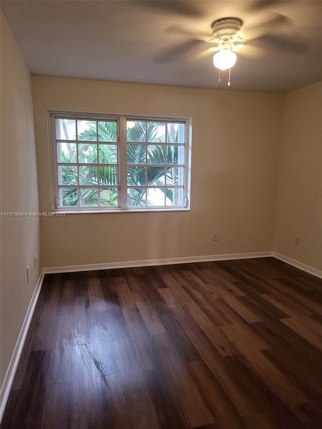 unfurnished room featuring dark wood-type flooring, ceiling fan, and a healthy amount of sunlight