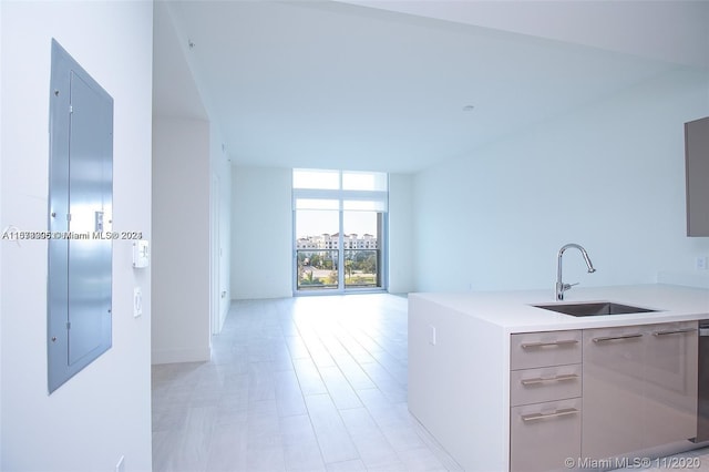 kitchen with floor to ceiling windows, sink, and elevator