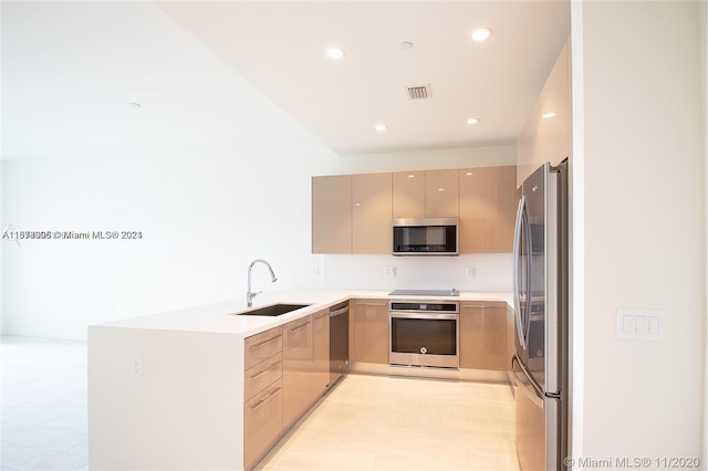 kitchen featuring appliances with stainless steel finishes, sink, light tile flooring, gray cabinets, and kitchen peninsula