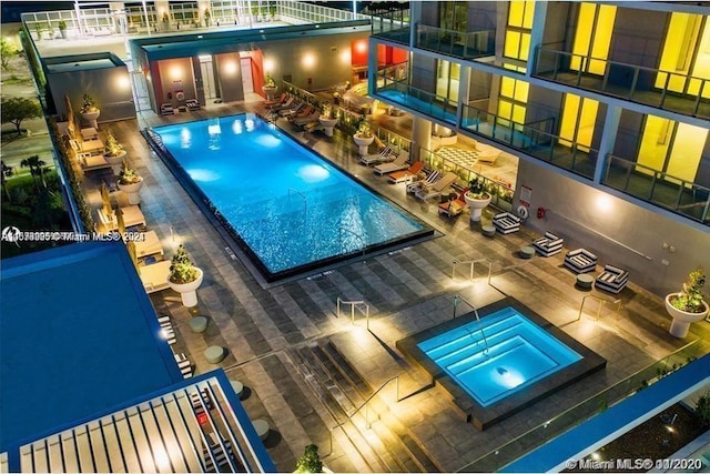 view of pool featuring a patio area and a hot tub