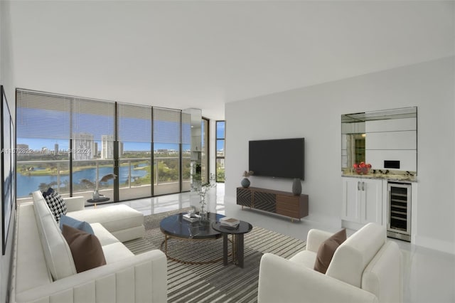 living room featuring bar area, a water view, wine cooler, and a wall of windows