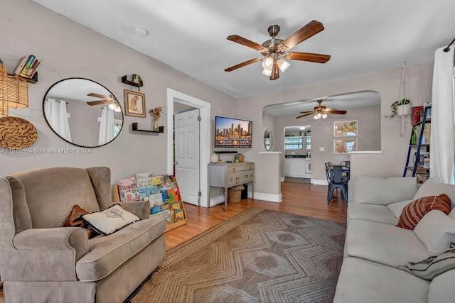 living room with ceiling fan and light wood-type flooring