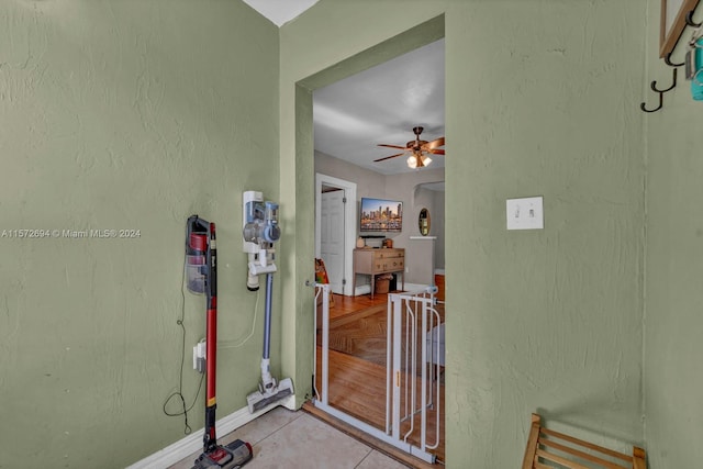 view of exterior entry featuring ceiling fan