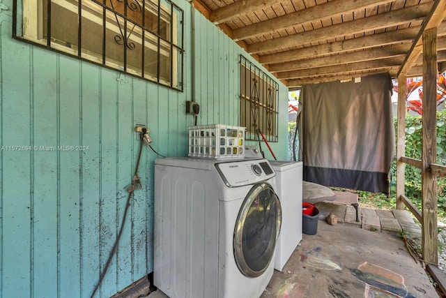 clothes washing area featuring separate washer and dryer and wood ceiling