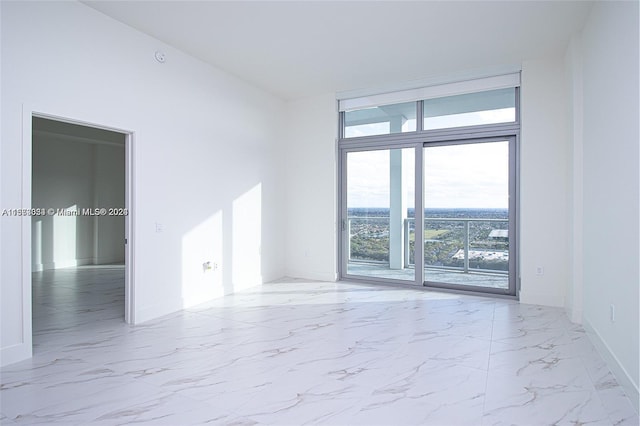 tiled spare room featuring a healthy amount of sunlight