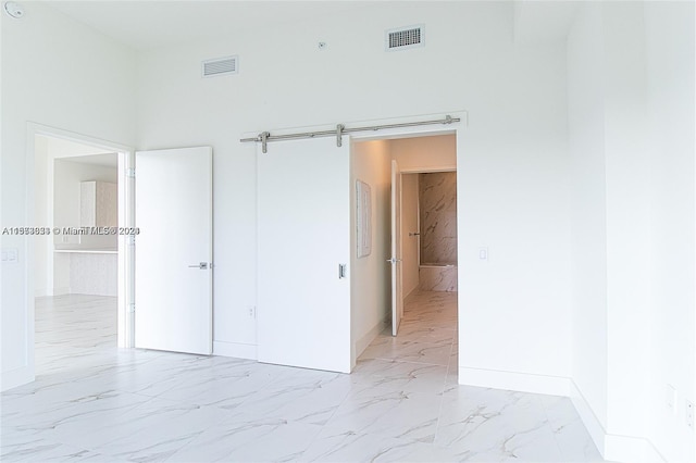 tiled empty room with a barn door