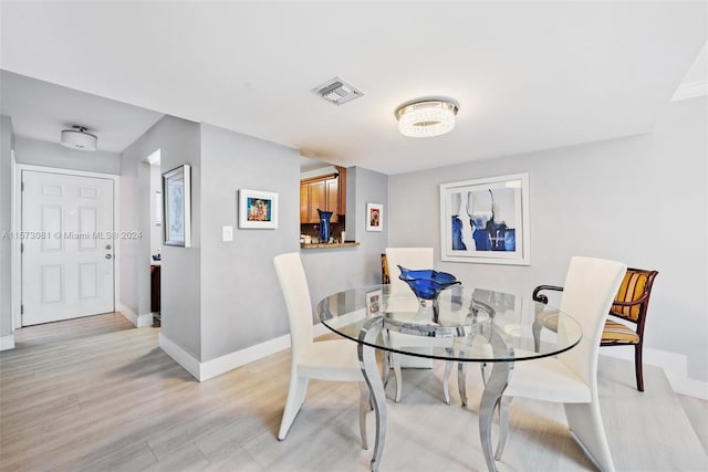 dining area with light hardwood / wood-style flooring