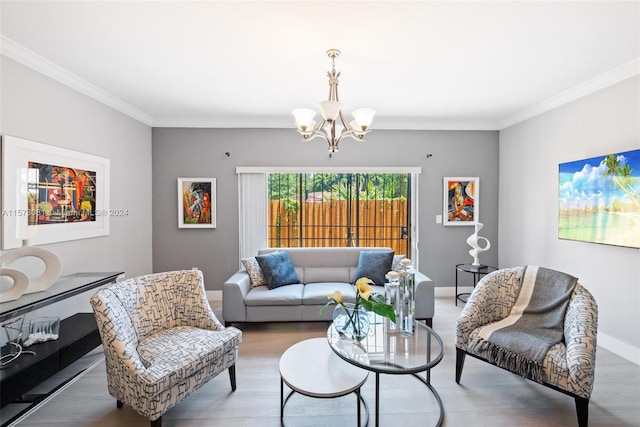 living room with ornamental molding, a notable chandelier, and hardwood / wood-style floors