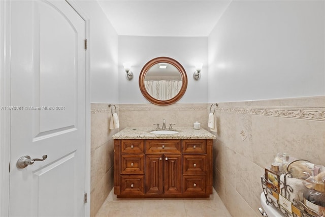 bathroom featuring vanity, tile patterned flooring, and tile walls