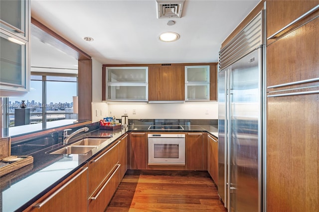 kitchen with dark hardwood / wood-style flooring, sink, and appliances with stainless steel finishes