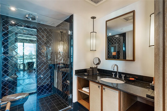 bathroom featuring vanity and an enclosed shower