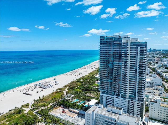 birds eye view of property with a view of the beach and a water view