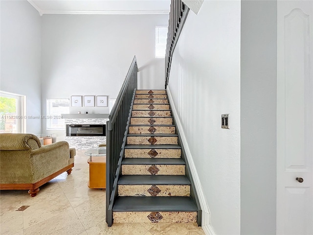 stairway featuring ornamental molding