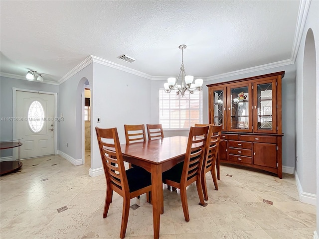 dining space featuring a textured ceiling, a notable chandelier, and crown molding