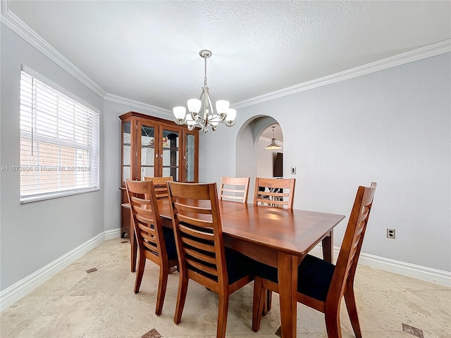 dining area with a textured ceiling, ceiling fan with notable chandelier, and crown molding