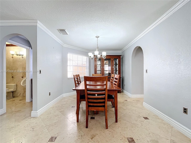 dining space featuring french doors, ornamental molding, a textured ceiling, and a chandelier