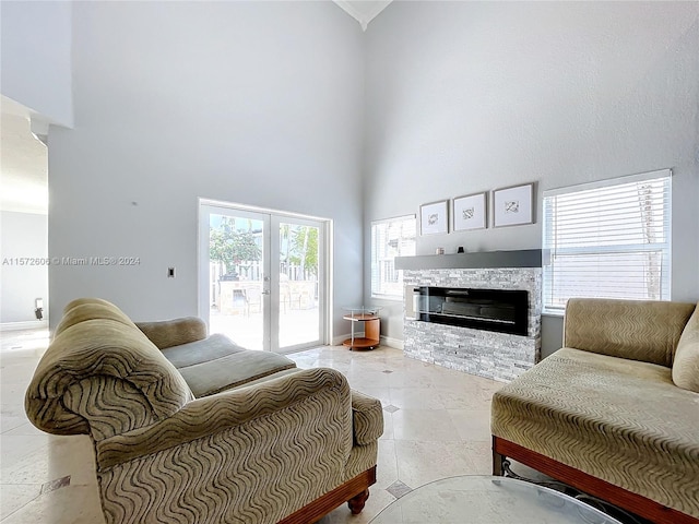 tiled living room with a fireplace and a towering ceiling