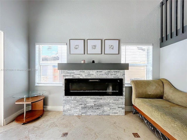 living room with a stone fireplace