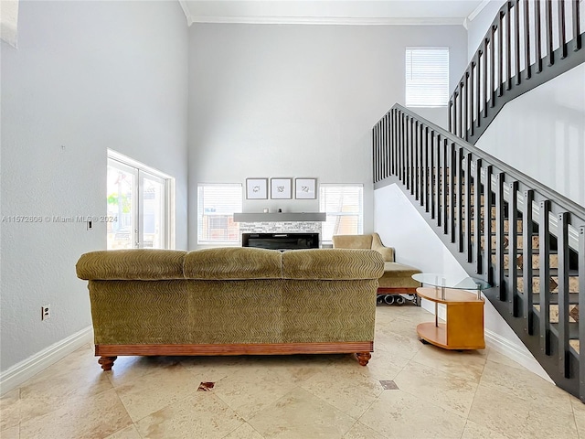 living room featuring ornamental molding and a high ceiling