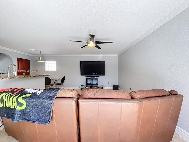 living room with ceiling fan, sink, and crown molding