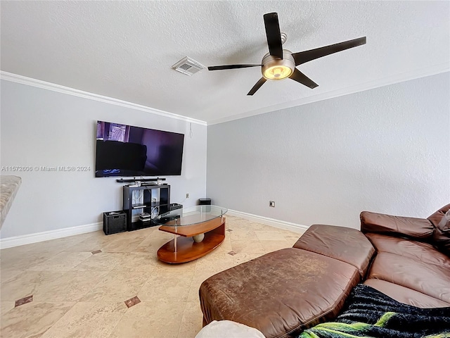 living room featuring crown molding, ceiling fan, and a textured ceiling