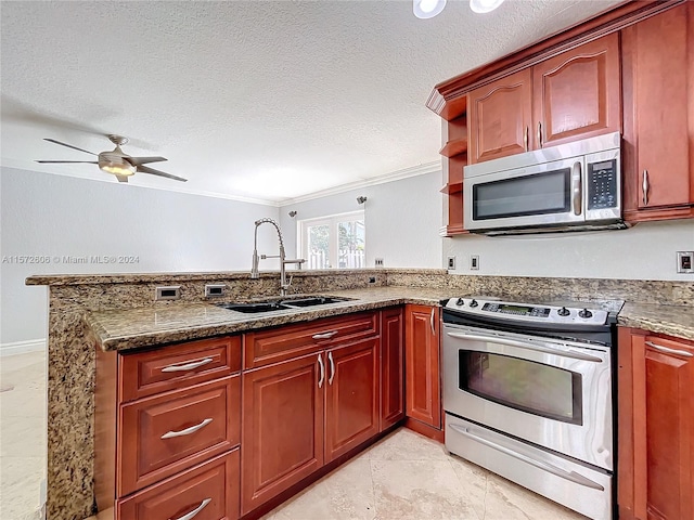 kitchen with ceiling fan, sink, crown molding, dark stone counters, and appliances with stainless steel finishes