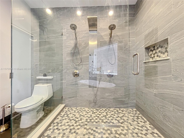 bathroom featuring toilet and walk in shower