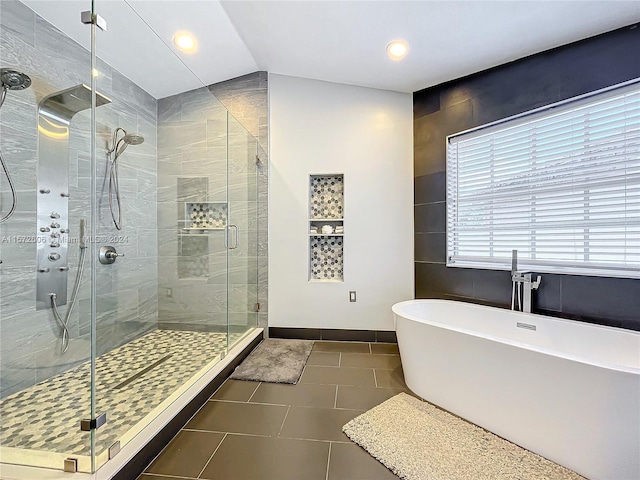 bathroom with tile patterned flooring, lofted ceiling, and shower with separate bathtub